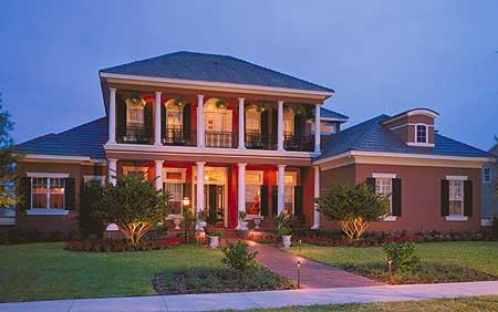 The Southern Colonial Red Brick Home design features a spacious 5,000+ square feet layout with a classic red brick exterior, white columns, and a grand entrance staircase. The interior boasts high ceilings, large windows, and luxurious finishes, creating a timeless and elegant living space perfect for entertaining and family gatherings.
